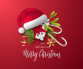 The realistic 3D decorations on this festive vector card are Santa's hat, a gift box with a bow, candy canes, mistletoe and fir branches. Red background with Merry Christmas text for holiday banners.