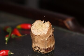 Fresh Ginger Root with Red Chili Peppers on Dark Background – Natural Cooking Ingredients Close-Up