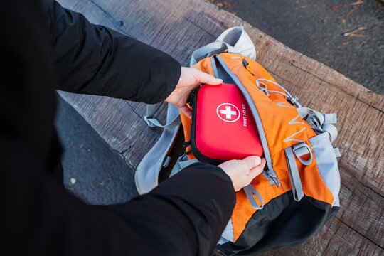 Preparing medical gear outdoors, Organizing safety supplies for family outdoor exploration, Ensuring all necessary health and safety items are packed for family outings in nature