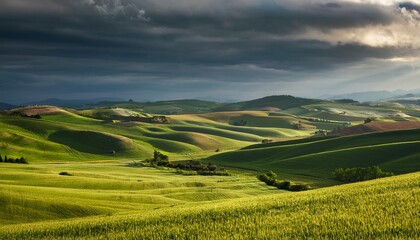 Obraz premium rolling hills and fields under a dramatic sky