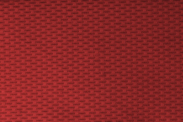 Close up of a textured red sport mesh fabric with a subtle woven pattern