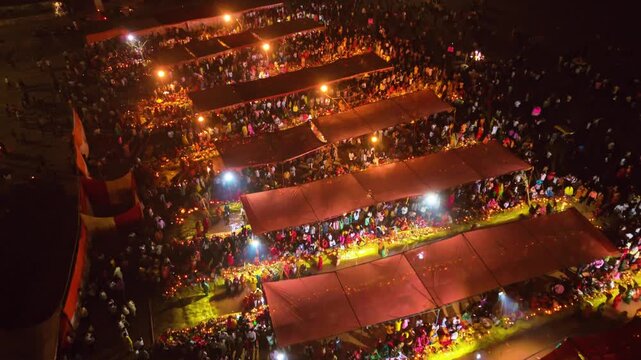 Beautiful night-style drone view of Chhath Puja Usha Arghya in Bihar. Rows of devotees worship Chhathi Maiya along the glowing riverbank.