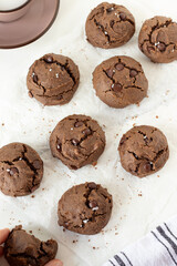 Chocolate chip cookies on white parchment paper. Top view.