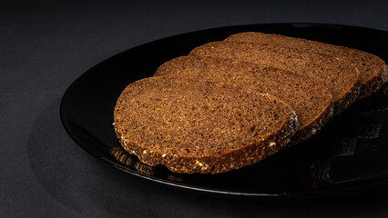 Slices of rye bread isolated on black background