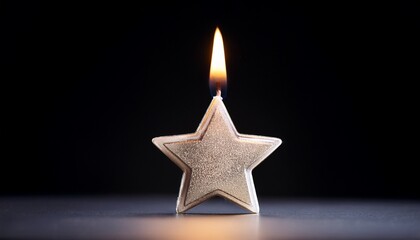 single star candle burning brightly on dark background