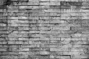 Old grunge weathered gray brick wall background texture