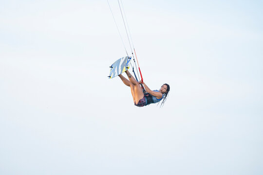 Female kitesurfer performing a jump over the ocean in La Guajira