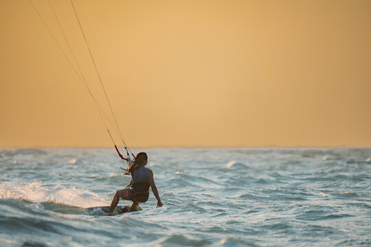 Woman kitesurfing in Mayapo, La Guajira under the sunset