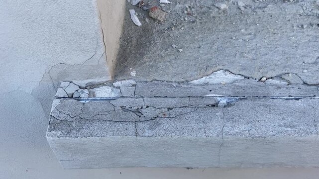 Close-up of cracked plaster and chipped window sill on new modern building wall, 4K construction defect footage	