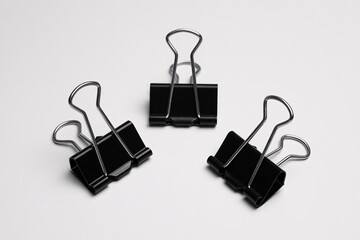 Stock photo of black binder clips office supplies on white background close up