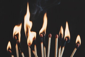 Burning matches close up on a black background fire flame ignition danger