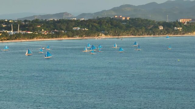 Top view of paraw sailing boats running over the turquoise water. Boracay, Philippines.