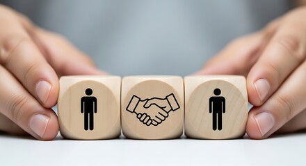 Two people shaking hands represented by icons on wooden blocks