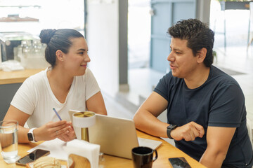 Hispanic couple working together at a bakery