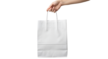A hand holding a white paper shopping bag with rope handles against a black background studio shot