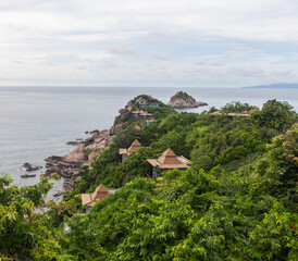 Fototapeta premium Luxurious Sai Daeng Resort nestled on the green hillside of Koh Tao island overlooking the tranquil sea.