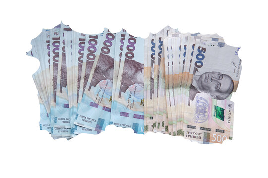 Stack of torn Ukrainian hryvnia banknotes, including 1000 and 500 bills, isolated on transparent background as a symbol of inflation.