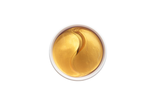 Gold hydrogel eye patches on white background.