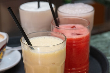 Bartender serving refreshing non-alcoholic drinks with colorful garnishes at a party
