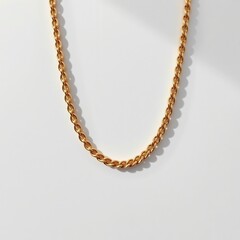 Obraz premium Elegant Gold Chain Necklace on White Background Perfect for Fashion and Jewelry Collection Displays