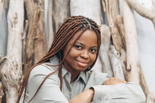 Portrait of a woman with beautifully braided hair on the background of a natural landscape