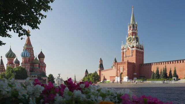 Red Square in Moscow. St. Basils Cathedral, Spasskaya Tower and flowers, Russia