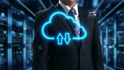 A businessman stands confidently in front of cloud technology icons, illustrating data transfer and digital security. The background features a modern data center. Qubit - Powered by Adobe