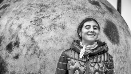 Young girl near Blue sculptural artwork featuring song thrush egg displayed outdoors near modern...