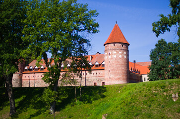 Historic brick castle with red roof and tower, Bytow, Poland