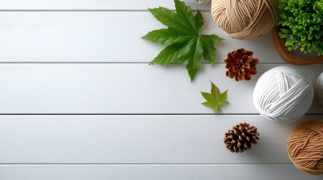 Soft wool yarn in natural shades sits with knitting needles and autumn leaves, inviting craft enthusiasts to create
