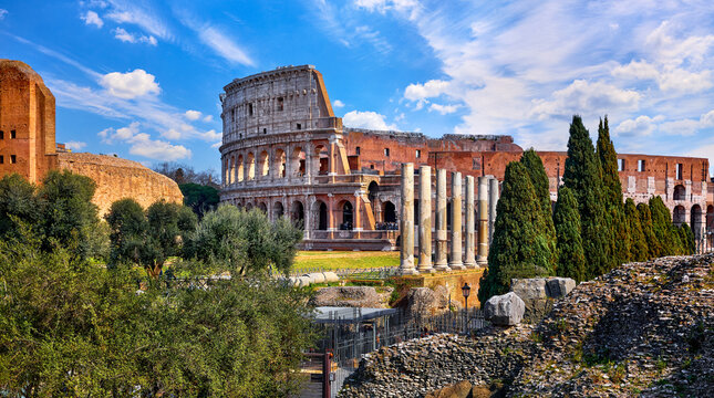 Rome, Italy. Roman Colosseum (Coliseum or Colosseo) Ancient Ruins of Flavian Amphitheatre. Arena for Gladiator Fightings. World Famous Landmark and Very Popular Touristic Destination Vacation Trip.