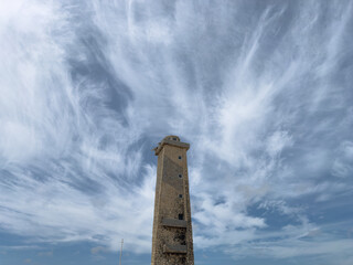 Ancient stone tower against a spectacular sky of cirrus clouds - Cape San Rom&aacute;n, Falc&oacute;n, Venezuela