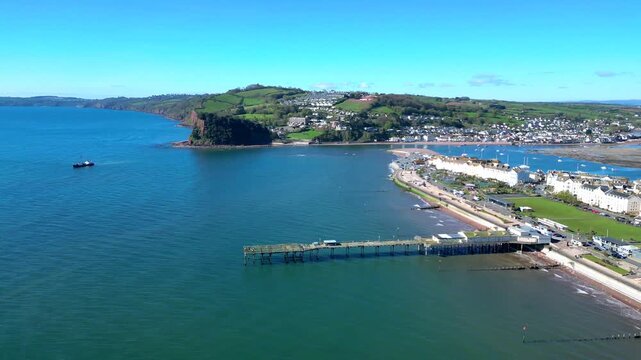 Teignmouth, South Devon, England: DRONE VIEWS: The drone circles the Grand Pier showing the River Teign in the background. Teignmouth is a port town and popular UK holiday destination (Clip 1 of 5).