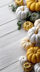 A collection of pumpkins in shades of orange and white, arranged neatly on a wooden surface, creating a warm fall scene