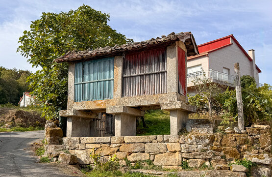 Traditional Galician h&oacute;rreo structure in a rural landscape, representing heritage and agricultural history in the Ribera Sacra wine region of Spain