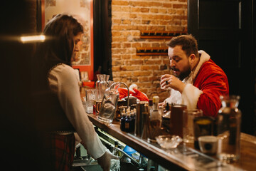 Santa claus relaxing having a drink at bar