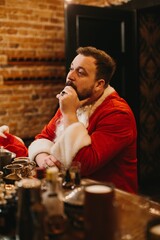 Thoughtful santa claus taking a well-deserved break at bar