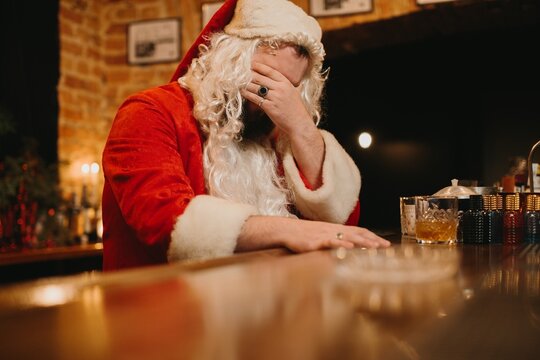 Santa claus feeling tired and stressed at bar