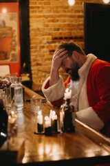 Stressed santa claus having a break at bar