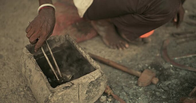 Cinematic shot of Indian blacksmiths forging tools like hoe, sickle, and  spade in a workshop