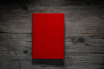 Red Book Cover on Dark Wood Table