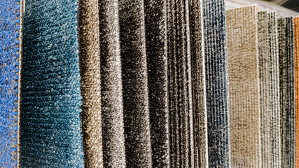 Macro photo of carpet samples with different pile types and colors. Ideal for interior design and flooring projects.