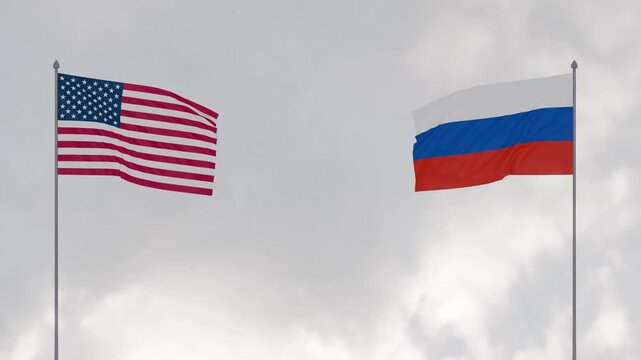 Flags of Russia and The United States waving together against cloudy sky background.
