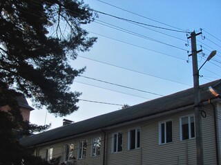 Old building with corrugated slate roof at dusk