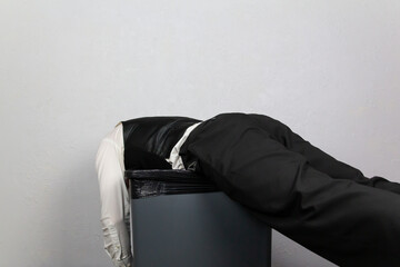 Businessman Thrown Onto Trash Can. Concept of Being Sacked or Fired.