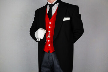 Butler or Hotel Concierge in Formal Attire and White Gloves Standing At Attention. At Your Service.
