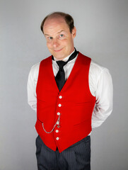 Butler or Hotel Concierge in Gorgeous Red Vest or Waistcoat Eager to Be of Service. Professional Hospitality and Courtesy.