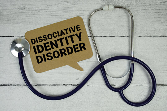 Dissociative Identity Disorder text with Medical Stethoscope on wooden background - Powered by Adobe