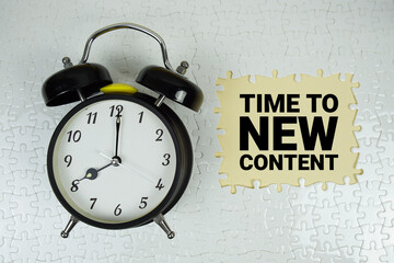 Time For New Content text with alarm clock on yellow background