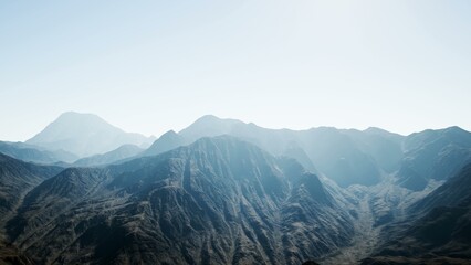 Fototapeta premium Breathtaking mountain ranges stretch across the horizon, bathed in soft morning light. The rugged terrain showcases the raw beauty of nature, inviting exploration and admiration.